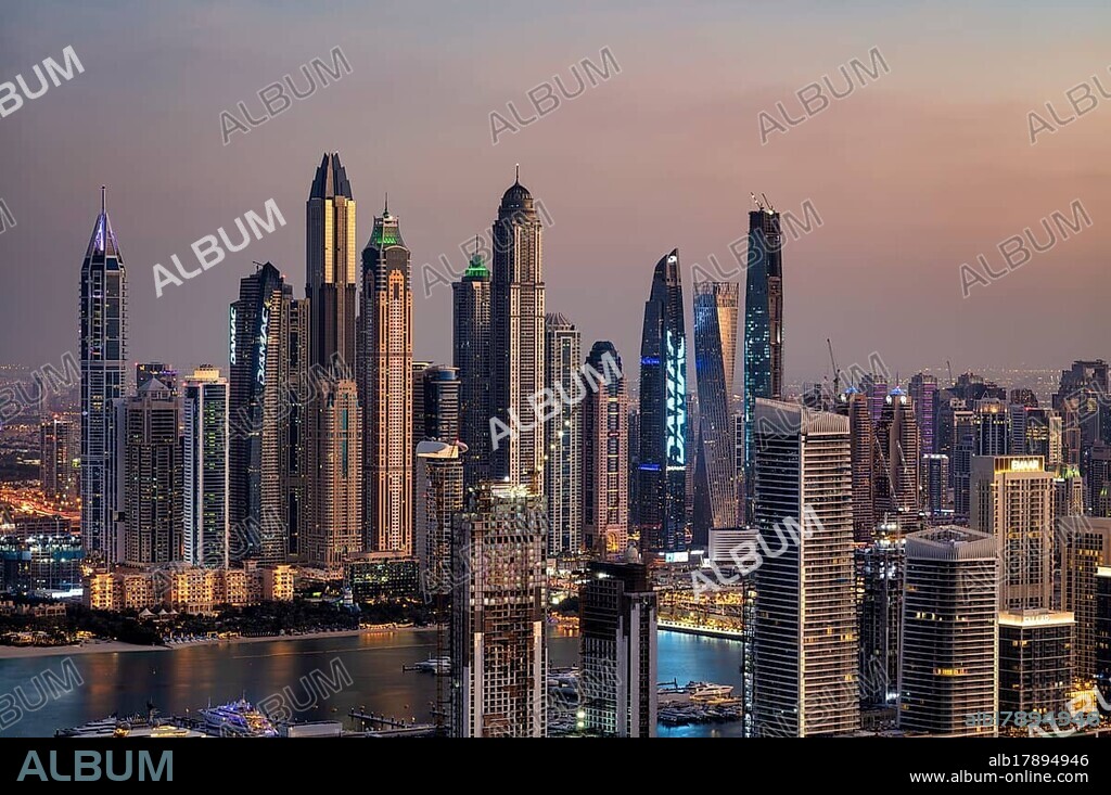 View of the skyline with Princess Tower, Elite Residence, luxury yacht OPERA owned by Sheikh Mansour bin Zayed Al Nahyan from the ruling family of the Emirate of Dubai, anchored in front of EMAAR Beachfront, Logo, DAMAC, evening mood, Dubai Marina, Dubai, United Arab Emirates, VAR