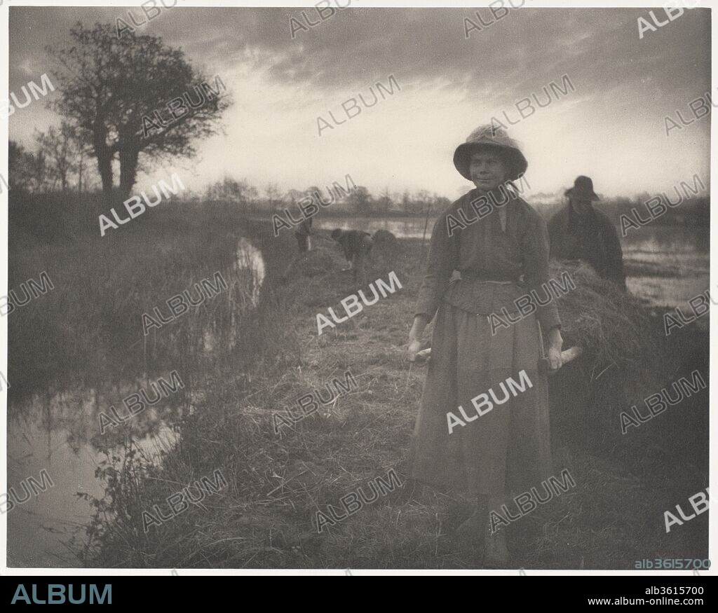Poling the Marsh Hay. Artist: Peter Henry Emerson (British, born Cuba, 1856-1936). Dimensions: Image: 23.2 x 29 cm (9 1/8 x 11 7/16 in.)
Mount: 28.6 x 40.9 cm (11 1/4 x 16 1/8 in.)
Sheet ((Interleaving Plate Sheet)): 28 x 40.7 cm (11 x 16 in.). Date: 1886.
P. H. Emerson's book "Life and Landscape on the Norfolk Broads," in which this image was one of forty plates, was the artist's first demonstration of the naturalism that he advocated for photography. While seeking the same goal as his ideological opposite, H. P. Robinson--recognition of photography as a fine art--Emerson drew his subjects not from literary narratives, but rather from an examination, at once both highly personal and anthropological, of the environment and daily rituals of rural life in East Anglia, the marshy coastal region northeast of London. Adamantly, even vociferously, opposed to Robinson's artificial manipulation of the medium, Emerson admitted into his own photographic vocabulary only selective focus and the careful gradation of tones, subtly rendered here by the platinum process. He looked to the work of painters for his aesthetic models, Jean-François Millet and Jules Bastien-Lepage in France and, at home, the painters of the New English Art Club, including his collaborator on "Life and Landscape," Thomas Goodall. In breaking the existing molds of ambitious photography--sharp, straightforward documentation and contrived tableaux--and opting for a more impressionist vision, Emerson blazed the trail that would be followed by the American Pictorialists, the Photo-Secession, and modern photography.
Emerson immersed himself in the life and work of East Anglia, passing on his expertise in more than a half-dozen books illustrated with platinum prints or photogravures during his ten-year photographic career. But "Poling the Marsh Hay" is more than just an accurate depiction of the means by which Norfolk peasants transported their harvest over ground too sodden to traverse with carts; it is an essay on the nobility of manual labor and a meditation on nature and mortality. Below ominous dark clouds the assertive strong-bodied woman in the foreground and the shadowed figure behind pole their hay as if carrying a funeral litter.