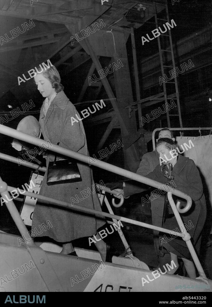 Boarding Royal Tour Liner - To Wish 'Bon Voyage' To Lord Althorp -- Lady Fermoy (carrying sword) follows her daughter, seventeen-year-old Miss Frances Roche, up the gangway to board the Royal tour liner Gothic at King George V Dock, London, this evening (Tuesday). They were going aboard to wish 'bon voyage' to Viscount Althorp (fiance of Miss Roche) who is Equerry to the Queen. Later the liner was leaving for Jamaica where the Queen and the Duke of Edinburgh will go aboard on November 27 for the start of the royal tour of Australia and New Zealand. The Gothic will take the royal party to the Antipodes and will be used as a base ship during the tour. November 10, 1953. (Photo by Reuterphoto).