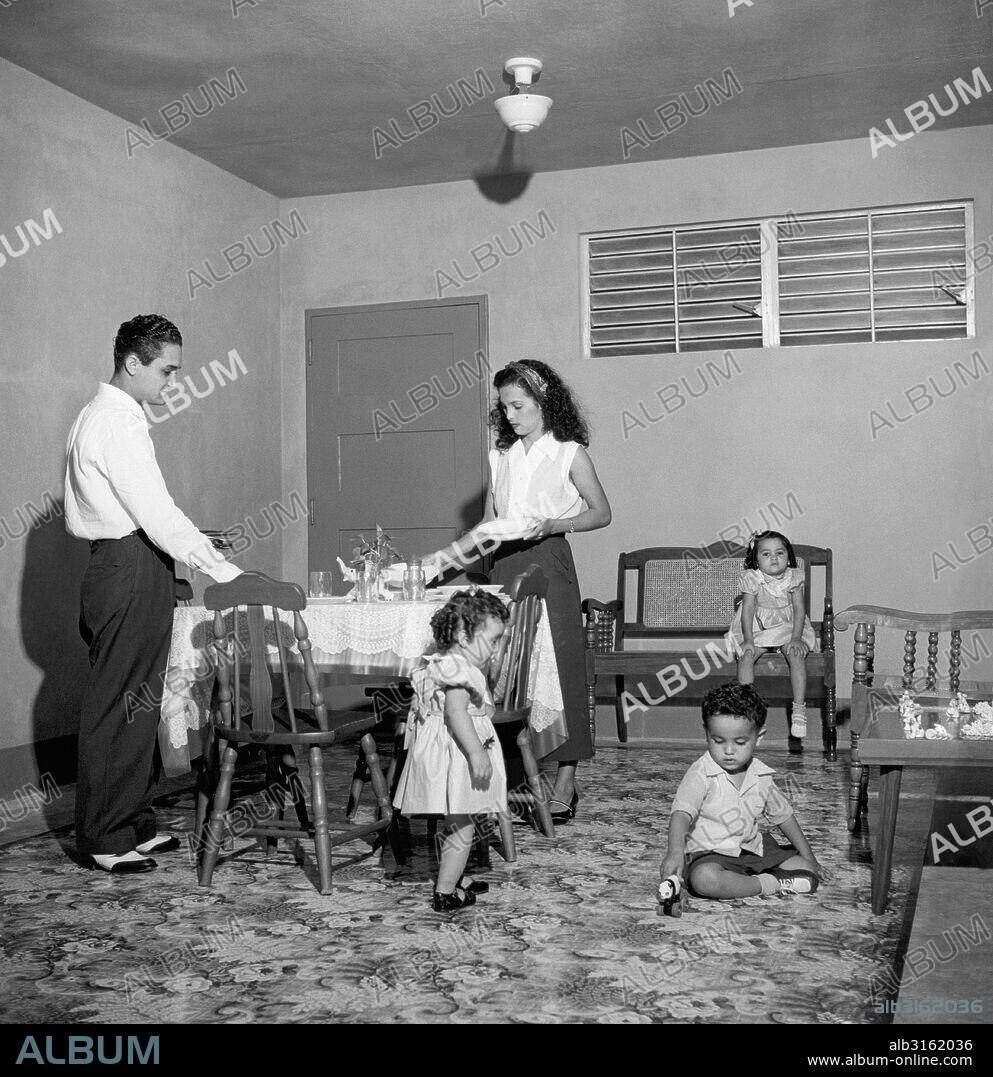 San Juan, Puerto Rico: September, 1953. A family gets ready for their first family dinner in a new apartment at the Llorens Torres Housing Development.