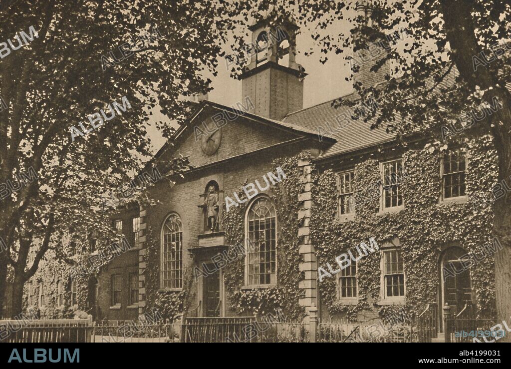 'Old Almshouses in the Kingsland Road Turned Into a Furniture Museum', c1935. The Geffrye Museum of the Home on Kingsland Road in Shoreditch, north-east London, is housed in 18th-century almshouses which were built in 1714 by Sir Robert Geffrye, a former Lord Mayor of London and Master of the Ironmongers' Company. The front facade, seen here, has a statue of him in the niche below the clock.  From "Wonderful London, Volume 3", edited by Arthur St John Adcock. [The Fleetway House, London, c1935].