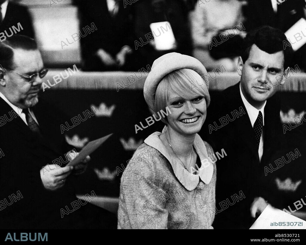 Arkiv 1965. Karin Stenbäck, svensk landslagssimmare på 60-talet med flera rekord och mästerskapstitlar på favoritdistansen 100 meter fjäril. Här tillsammans med maken Per Martin vid National musei Vänners samkväm i Rikssalen i samband med 100-årsjubiléet.. Fopto: Reportagebild Kod:37770.