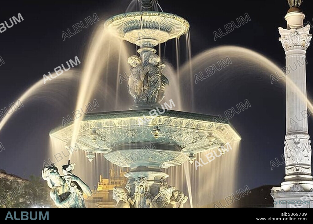 Bronze fountain and statue of King Pedro IV in the square Praca Rossio at night, Baixa District, Lisbon, Portugal, Europe.