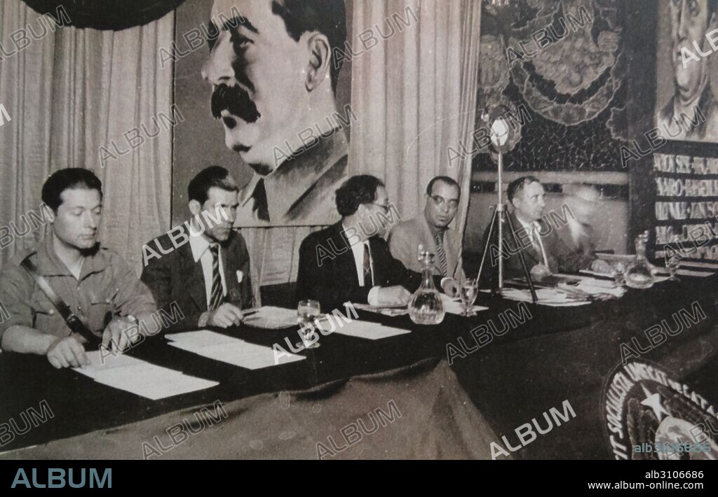 Joan Comorera (4th from left) talks to Rafael Vidiella at a meeting of the PSUC Alliance during the Spanish Civil War. The Unified Socialist Party of Catalonia (Catalan: Partit Socialista Unificat de Catalunya, PSUC), was formed on 23 July 1936 through the unification of four left-wing groups; the Catalan Federation of Spanish Socialist Workers' Party (PSOE), the Partit Comunista de Catalunya (Communist Party of Catalonia, the Catalan branch of the Communist Party of Spain, PCE), the Unió Socialista de Catalunya (Socialist Union of Catalonia) and the Partit Català Proletari (Proletarian Catalan Party).