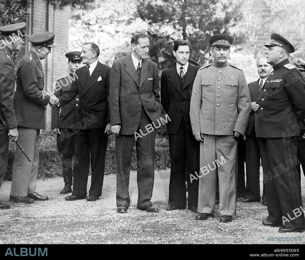 U.S. General George C. Marshall, Chief of staff of USA, shaking hands with Sir Archibald Clark Keer, British Ambassador to the USSR, Harry Hopkins, Marshal Stalin's interpreter, Marshal Josef Stalin, Foreign minister Vyacheslav Molotov, General Kliment Voroshilov, during Tehran Conference, Tehran, Iran, U.S. Army Signal Corps, November 1943.