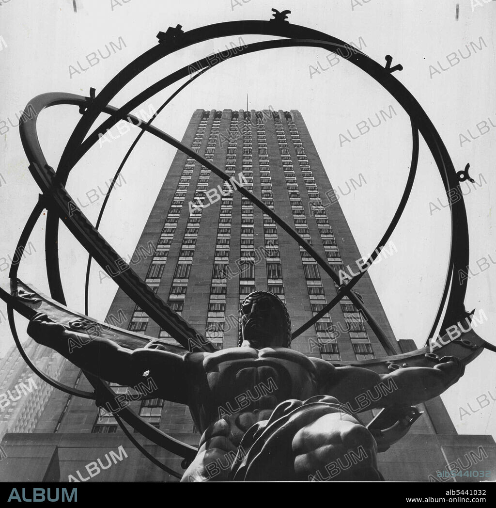 Shooting Spree (First Of Twelve) -- One of the towering structures of Rockefeller Center looms behind this statue of mighty Atlas, a favorite target for visiting amateur cameramen. Easily one of the most photographed landmarks in Manhattan, the bronze burden of having to contend with shutterbugs who swarm over the area each day. July 15, 1955. (Photo by United Press).