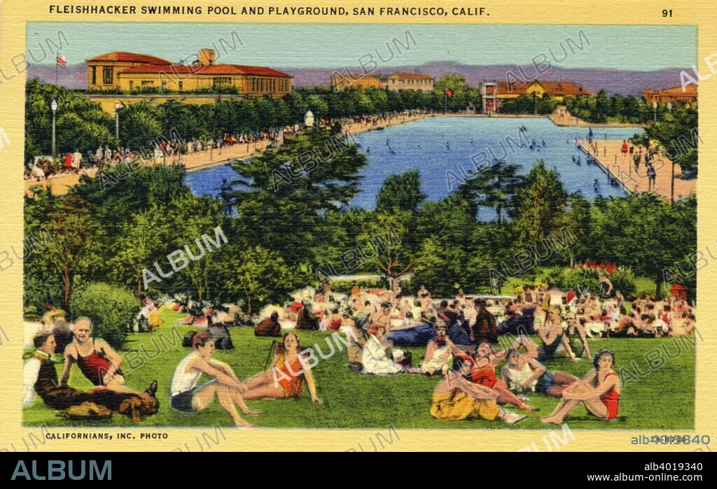 Fleishhacker Swimming Pool and Playground, San Francisco, California, USA, 1932. Vintage linen postcard showing the world's largest outdoor, heated swimming pool and the surrounding grounds. Dozens of bathers sit on the grass in the foreground. Opened in 1925, the pool measured 300 by 50 metres and held 24,600,000 litres of seawater, pumped in from the Pacific, filtered and heated. It was demolished in 2000.