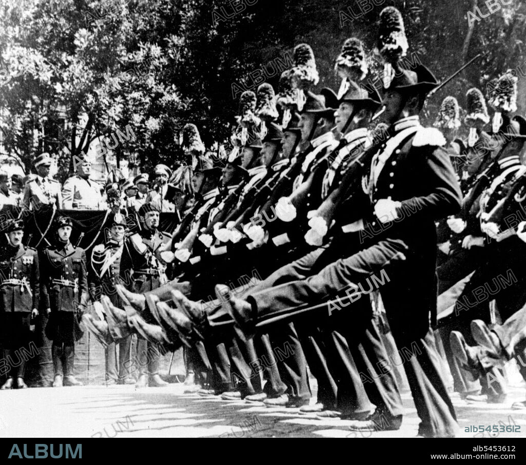 Celebrating Anniversary of Foundation of Famous Italian Regiment.Members of the Carabinieri do the "Roman Step" as they parade past Mussolini during the parade.Mussolini was present at a great parade held in Rome to celebrate the 124th anniversary of the foundation of the famous Italian Carabinieri. He presented medals and decorations. July 6, 1938. (Photo by Keystone).