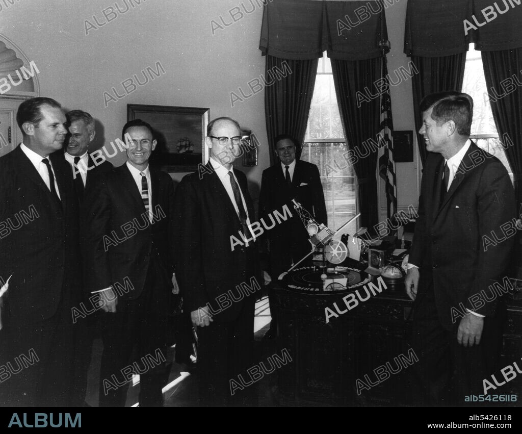 Kennedy Receives Mariner 2 Model, 1961. Dr. William H. Pickering, (center) Jet Propulsion Laboratory Director, presenting Mariner spacecraft model to President John F. Kennedy, (right). NASA Administrator James Webb is standing directly behind the Mariner model. The Mariner 2 probe flew by Venus in 1962 after the failure of Mariner 1, sending back data on its atmosphere, mass, and weather patterns. It stopped transmitting in 1963 after delivering a wealth of scientific information.