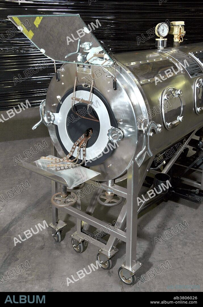 Made of stainless steel, and still in good working order, this Emerson respirator, more commonly referred to as an "iron lung" is shown from the anterior, or front view. Devices such as these were used by polio patients whose ability to breath was paralyzed due to this crippling viral disease. This particular iron lung was donated to the CDC's Global Health Odyssey by the family of polio patient, Mr. Barton Hebert of Covington, Louisiana, who'd used the device from the late 1950's until his death in 2003. Notice the mirror attached over-head that enabled Mr. Hebert to see above, or behind his head. The chamber is used to create a negative pressure around the thoracic cavity, thereby, causing air to rush into the lungs to equalize intrapulmonary pressure. J. H. Emerson Co. manufactured this type of life saving respirator in the 1930s, but in the 1950's and '60's, the invention of portable ventilators made iron lungs obsolete. By 1970, J. H. Emerson Co. ceased manufacturing this apparatus, but many still depend on such mechanical ventilation systems on a daily basis.