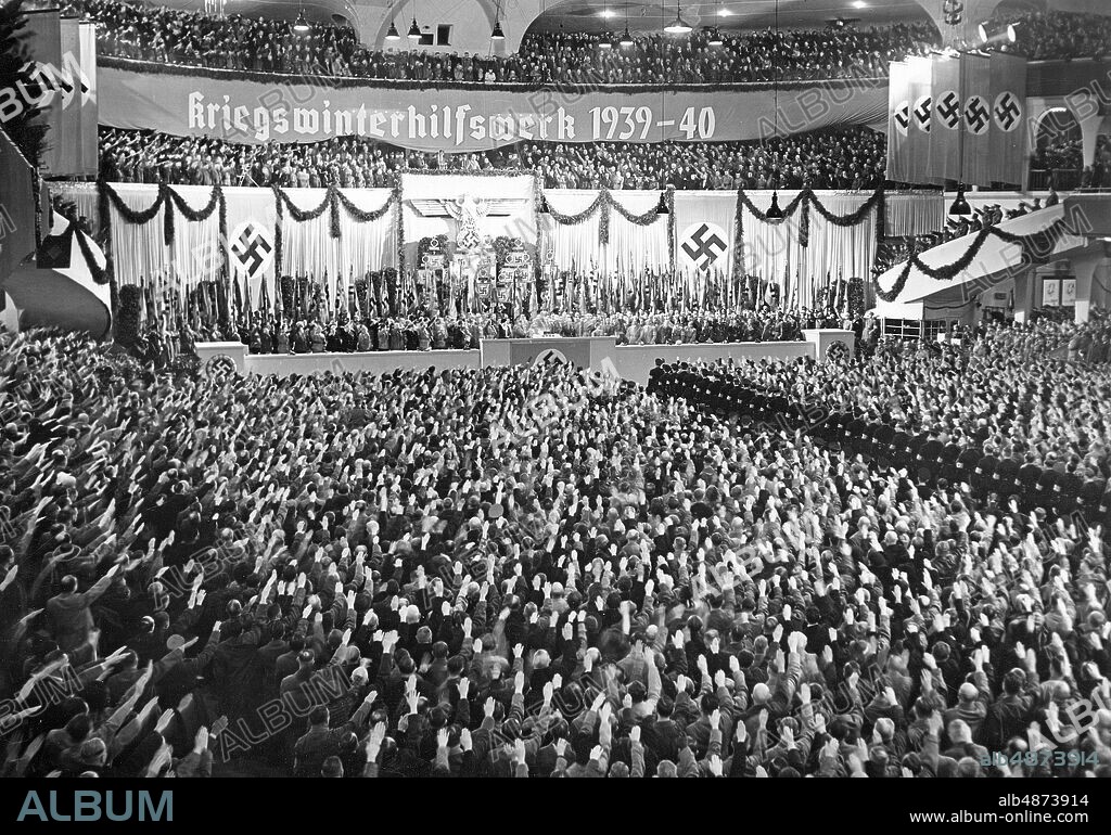 GERMANY BERLIN 1939-10-10. THE OPENING OF THE KIEGS WINTER AID WORKS 1939/40. Our picture takes a look at the Berlin Sports Palace during the opening announcement on Tuesday afternoon. The audience enthusiastically cheers for the leader to begin his grand speech. Photo: Scherl Bilderdienst / AB Text & Bilder / SVT / Code: 5600 Folder: Germany during the war: War winter aid. V85: 1B Swastika Nazi Greetings Kriegswinterhilfswerk sites: BERLIN; GERMANY.