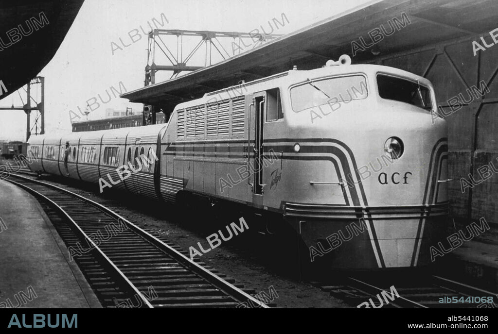 New Train Hits Speed Of 102.8 MPH -- A new experimental train that hit a speed of 102.8 miles per hour on the New Haven & Hartford railroad slows down entering the South Station after a demonstration run here today. The train consisted of a diesel electric locomotive and six articulated units. Its features are a low center of Gravity--it's two feet lower than an ordinary train, light weight, 75 per cent lighter then a regular train, and guided axles which permit it to take curves at high speed. Patrick B. McGinnis, new President of the road said the new train may be the answer to his promise of 2½ hour service between New York and Boston in the near future. June 29, 1954. (Photo by AP Wirephoto).