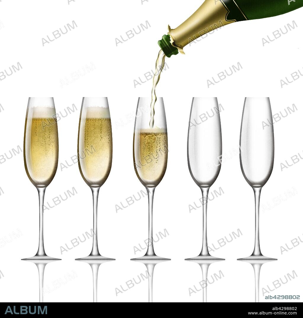 Champagne bottle pouring into flutes on white background.