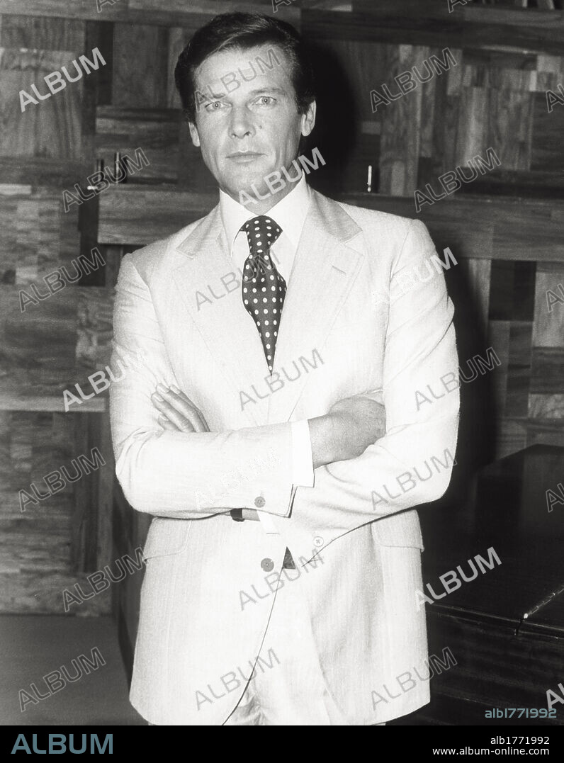 Portrait of Roger Moore. The English actor Roger Moore poses in front of the photographer. Rome, 1974.