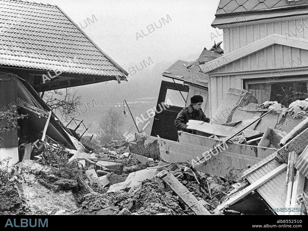 TUVE 1977-12-01. Räddningstjänsten tillsammans med boende i området röjer upp och tar hand om personliga tillhörigheter bland husruinerna dagen efter det kraftiga jordskred som drabbade villa- och radhusområdet i Tuve på Hisingen i Göteborg 30:e november 1977 där nio personer omkom och ett åttiotal skadades i rasmassorna. Omkring 700 personer blev hemlösa då ett sextiotal hus förstördes.. Foto: Leif Engberg / TT / Kod: 15. **SvD OUT**.