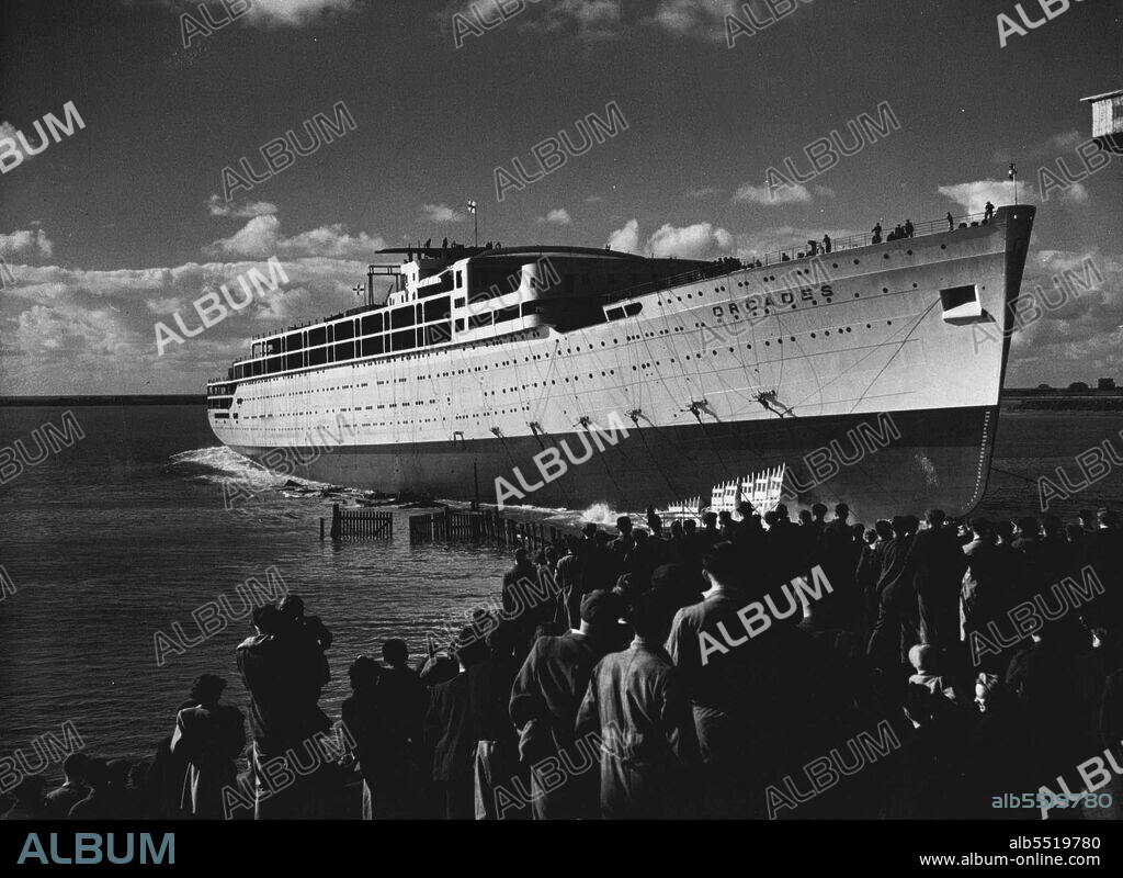 Largest Post-War Liner Launched -- The 31,000-ton liner "Orcades", built by Vickers-Armstrong for the Orient Line at their Barrow-in-Furness Yards, was launched yesterday by Lady Morshead, wife of the Sydney Manager of the Line. The "Orcades" is the biggest merchant ship in the world to be launched since the war, and has been built for the Australian trade at a cost of £3,000,000. It will carry over 1,500 passengers and 608 crew. The picture shows tugs fussing round the ship to take her out to the fitting out yards after the launch. October 15, 1947.