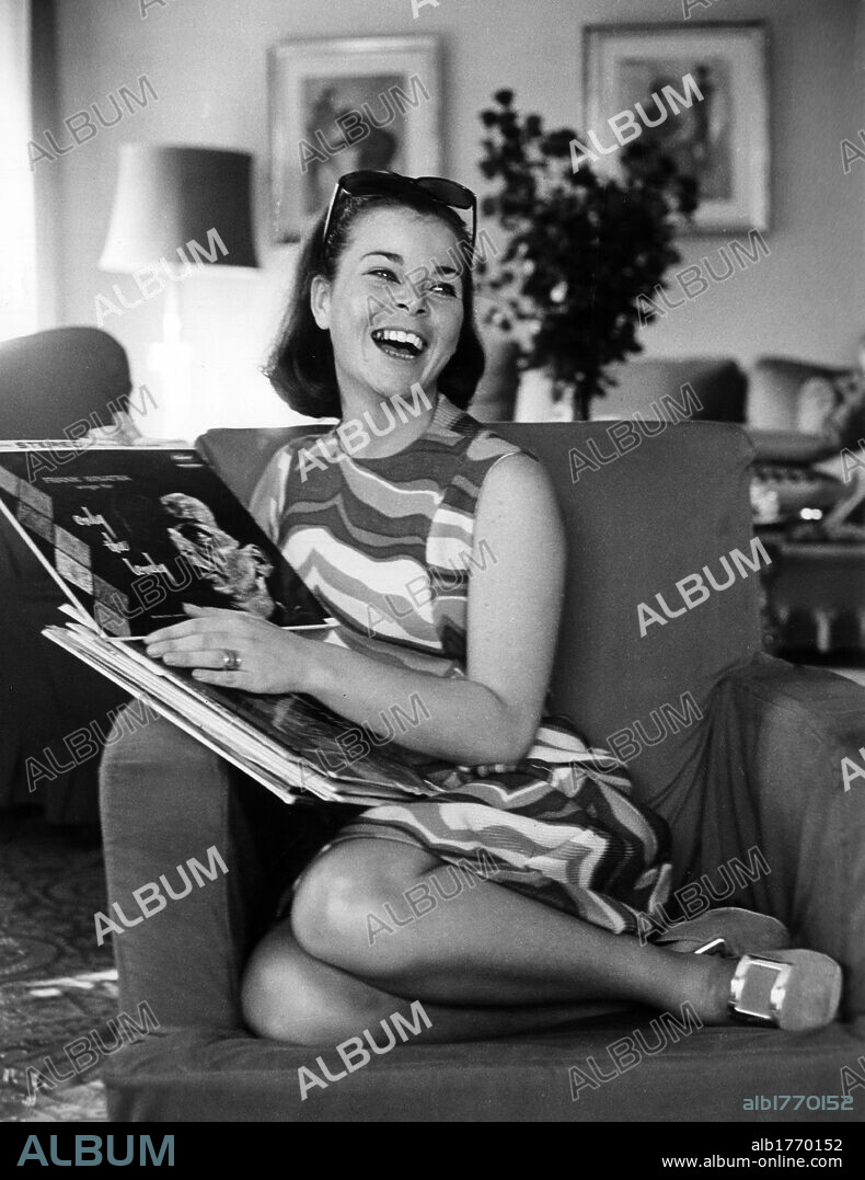 Maria Beatrice of Savoy laughing. Maria Beatrice of Savoy laughing while holding some records. Italy, 1967.