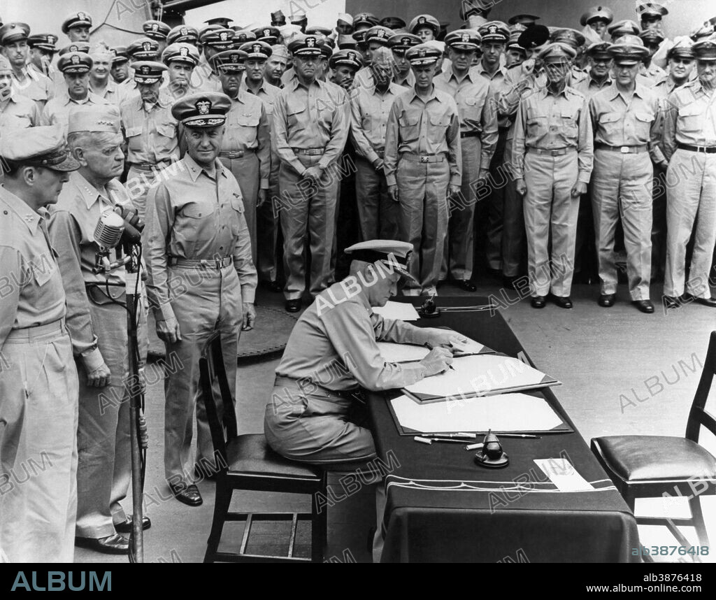 Vintage World War II History photo of Admiral Chester Nimitz signing the Japanese surrender documents aboard the USS Missouri. Standing behind Nimitz are General Douglas MacArthur, Admiral William Halsey, and Admiral Forrest Sherman.
