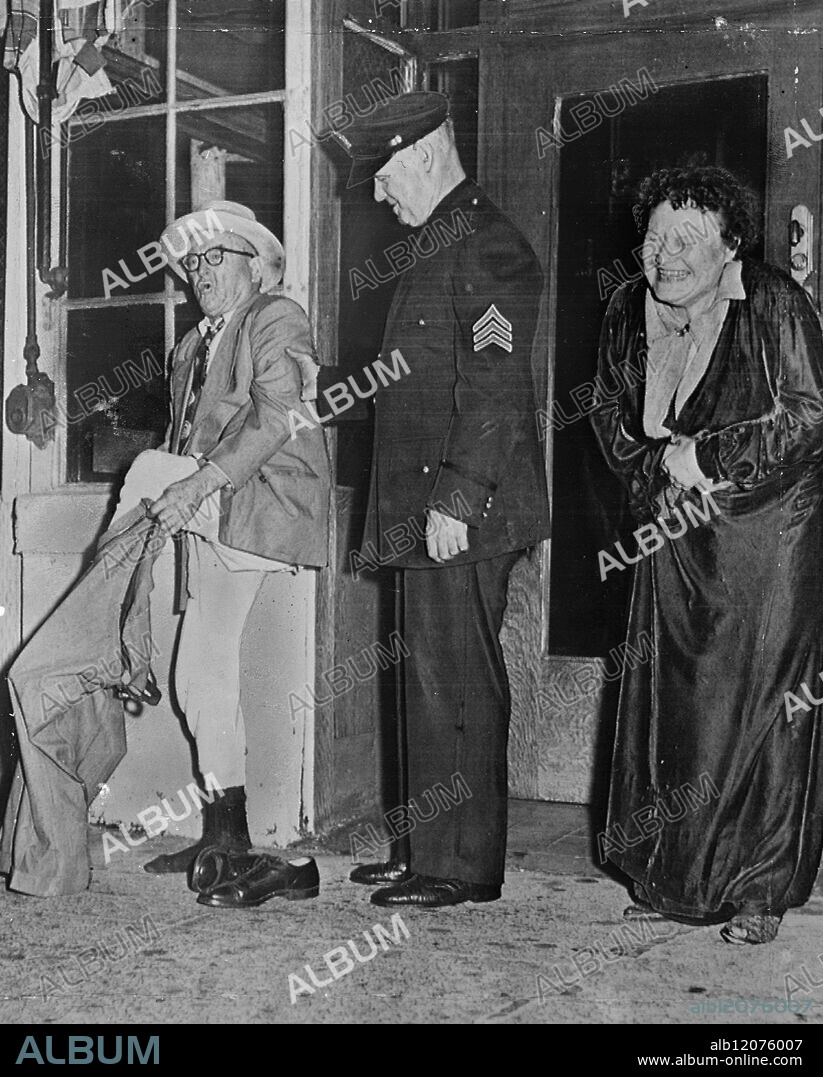 The laugh's on him - but the pants aren't. On September 16, 1953, John Guilfoy struggles to get into his pants after a recent hotel blaze, when flames forced tenants to flee in whatever they were wearing at the time. Mrs. Leota Emahiser laughs hysterically at the troubles of her neighbor, while police sergeant Frank Hughs lends a hand to bring the operation to a successful conclusion. Picture from San Francisco, California. International News Photos.