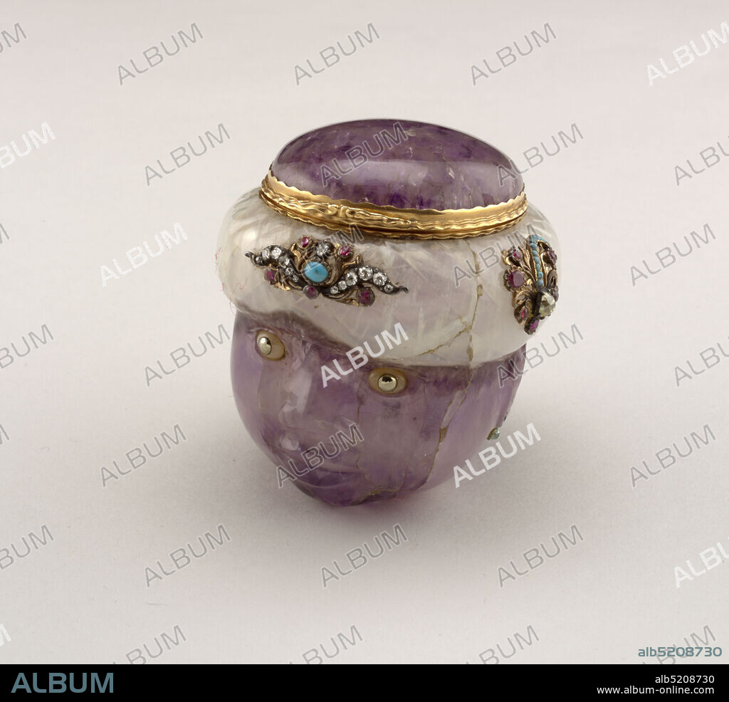 Snuff Box in Shape of a Moor's Head, amethyst, gold, silver, cut diamonds, rubies, emeralds, turquoise, moonstone, platinum, Box in form of a Moor's head; hinged cover; box and cover carved from single pieces of amethyst quartz in such a way that the natural white portions of the stone form the turban; surface highly polished except that hair is mat cut; eyes of moonstone with platinum (?) pupils at front and on left side of turban, applied floral ornaments set with rubies, turquoise and diamonds in gold and silver mounts; earrings each set with a rose diamond and small cabochon emerald; gold rims of box and cover carved with flame moldings and small scrolled thumb-piece., France, mid-18th century, containers, Decorative Arts, snuff box, snuff box.