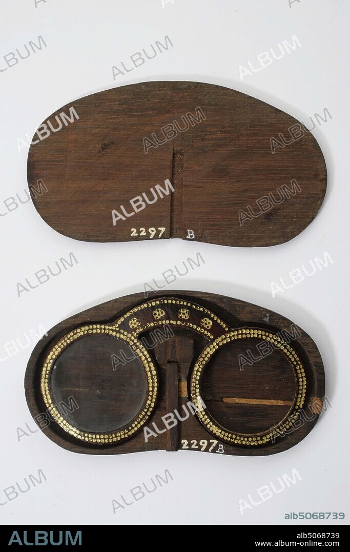 Anonymous, approx. 1800, leather, wood, glass, Glasses: 5.6 x 10.4 x 0.3cm 56 x 104 x 3mm, Box: 6.4 x 11.7 x 0.8cm 64 x 117 x 8mm, Goggles with brown leather frame with gilded decoration of dots and floral motifs. The glasses have two round lenses and an arc-shaped bridge. In accompanying flat dark wooden kidney-shaped sheath with cover, 1885.