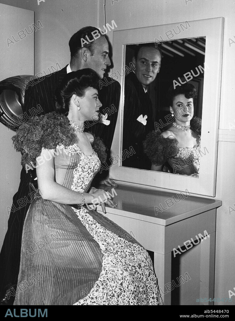 MGM's. famous hair stylist Sydney Guilaroff puts the finishing touches tot eh hair-dress worn by Leona when she was gowned in the costume worn by Kathryn Grayson in "The Kissing Bandit." January 20, 1950.