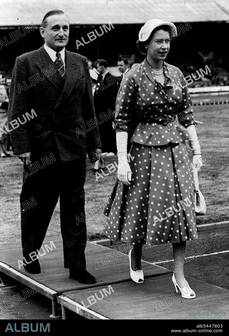 The Queen at White City -- The Queen walking with Lord Burghley, the famous Athlete, after arrival at the White City Stadium, London, this afternoon. The Queen accompanied by Princess MarGaret was cheered by 45,000 spectators when she arrived at the amateur Athletic association Championships at the White City, London, this afternoon . After driving round the track in her car the Queen met officials and Athletes in the Centre of the Arena. June 21, 1952. (Photo by Paul Popper Ltd.).