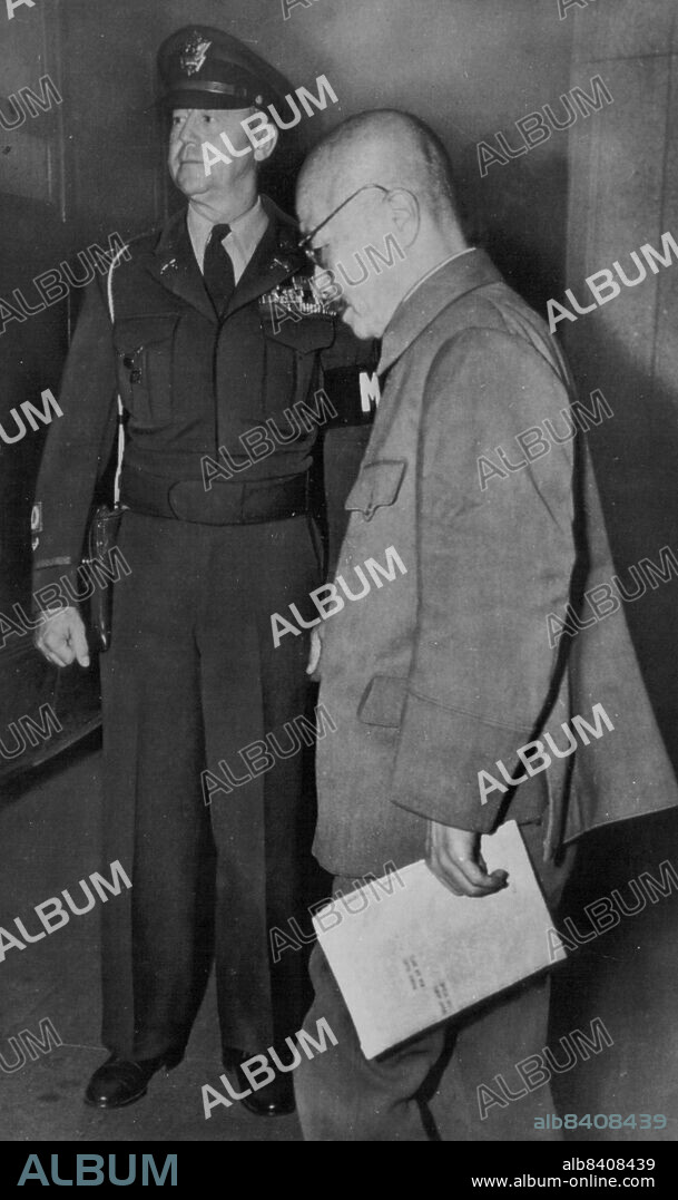 His Fate Decided -- Hideki Tojo (right) walks past guard as he leaves courtroom after session of his trial before International Military Tribunal in Tokyo, Nov. 7. The verdict in the long trial of Japan's wartime premier and 24 other defendants has been reached and the judgment of the court is being read today. Tojo and the others may learn their fate tomorrow. The defendants were blamed for one million war atrocity deaths in the judgment of the tribunal. November 11, 1948. (Photo by AP Wirephoto).