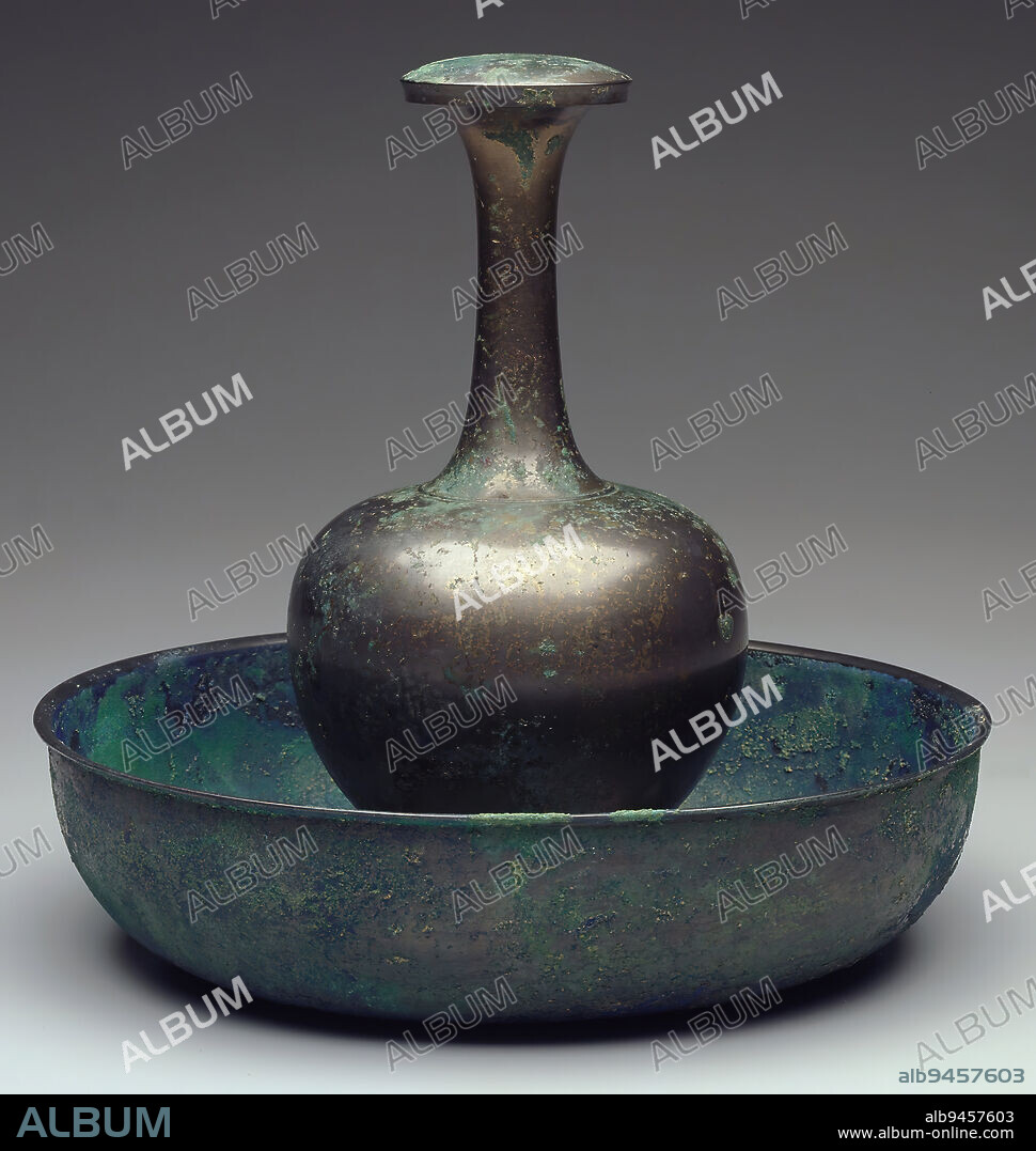 Ritual Buddhist Bottle Vase and Cover, 7th-8th century, 8 3/16 x 4 1/4 in. (20.8 x 10.8 cm) (vase without cover), Bronze, China, 7th-8th century, Made for Buddhist rituals, this finely finished, elegantly proportioned, lidded bottle vase and basin can be associated with the bodhisattva Guanyin (Avalokitesvara). Called an ambrosia vase, it is the type carried by Guanyin and is said to carry the elixir that comforts mortals who are seeking salvation.