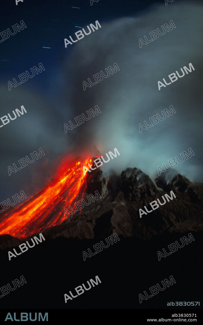 Soufriere Hills Volcano. Soufriere Hills is a stratovolcano on the island of Montserrat in the West Indies. It has an elevation of 3,002 feet (915 me) and began erupting on July 19, 1995. Photograph taken at night in 2002.