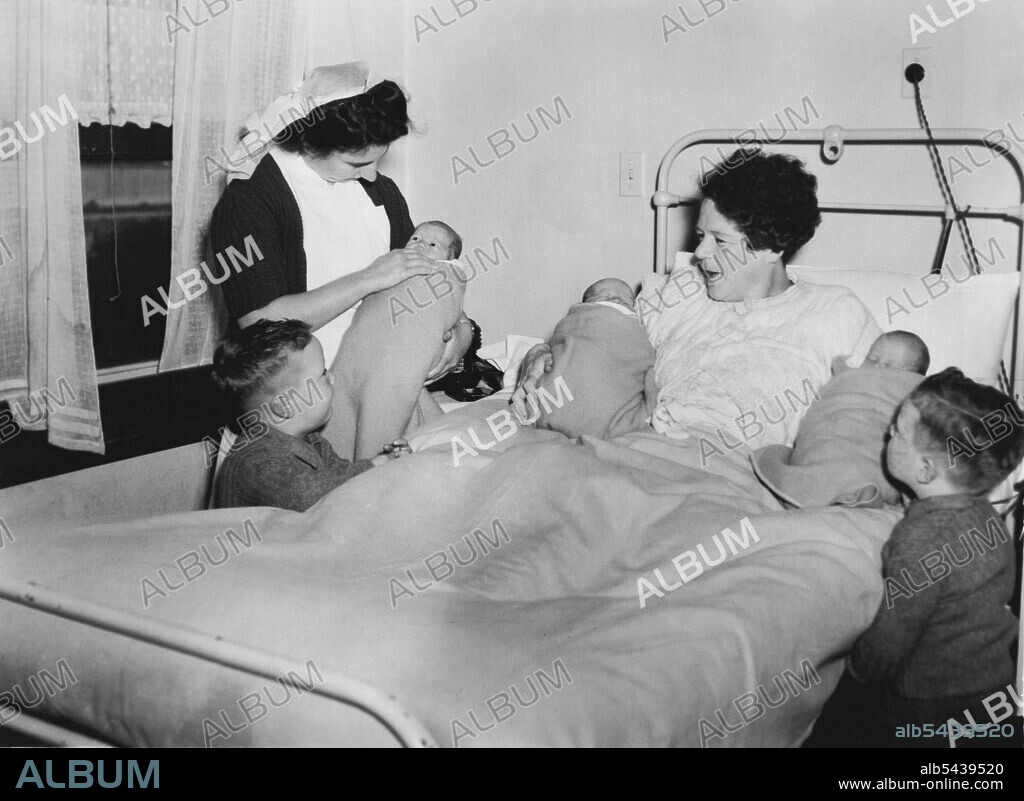 Twins Look At Their Three Baby Brothers - Mrs. L. Birthisel and her triplets, Gary Geoffrey and Peter (belived to be the world's heaviest-their combined weight at birth was 231lb. 1oZ) being visited by her twin sons. Terence and Bryan. aged 3½ at Yarrawonga Hospital. The twins are seen admiring their baby brothers. August 28, 1945.