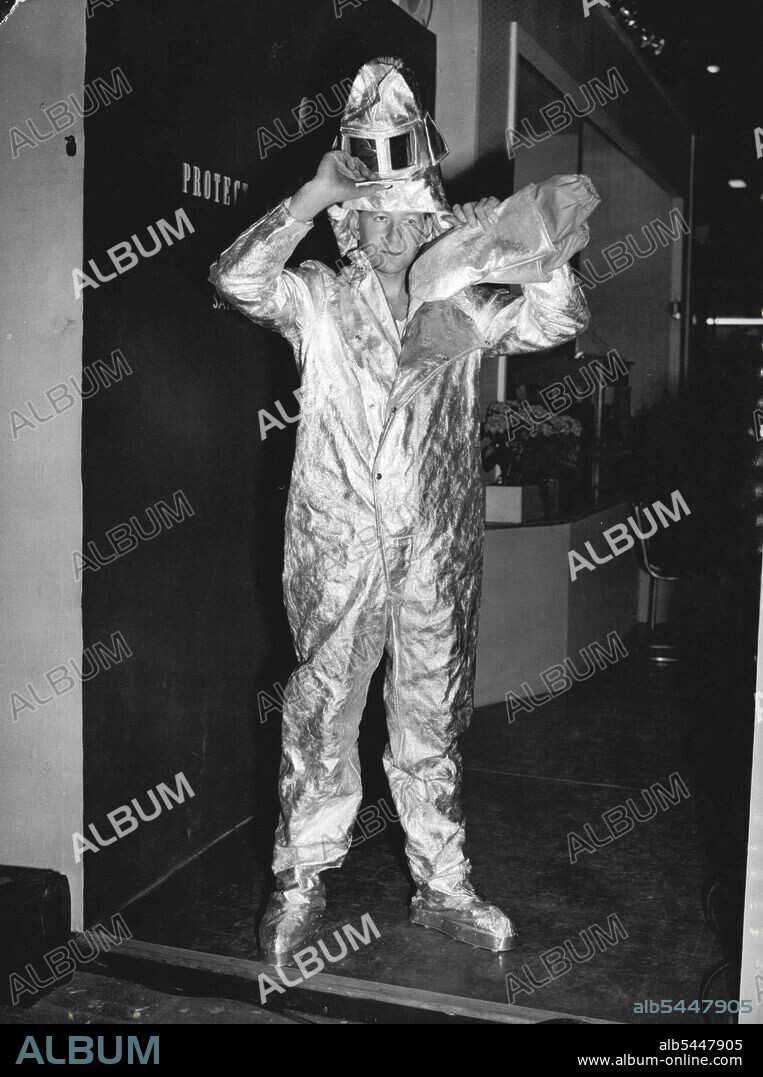 Aluminum Protection -- Aluminum foil makes this Siebe Gorman fire protection suit, which can resist a heat at 20 degrees centigrade, shown at *****. Factory Equipment Exhibition. ***** which opened at Earl's Court, ***** London, today (Monday). Ned Kelly would be envious of this aluminium foil suit, German designed, it won't stop bullets, but it is claimed to offer good Gre-protection, with standing heat at 200 deg centigrade. March 28, 1955. (Photo by Reuterphoto).