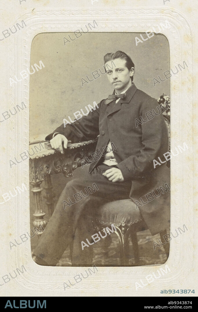 Studio portrait of a man at a table with ornaments, Albert Greiner (mentioned on object), Amsterdam, c. 1863 - c. 1866, paper, cardboard, albumen print, height 80 mm × width 54 mmheight 296 mm × width 225 mm.