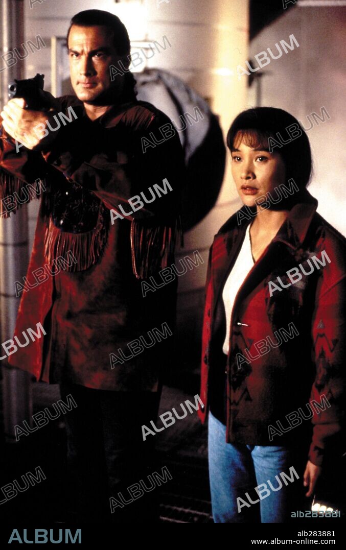 JOAN CHEN and STEVEN SEAGAL in ON DEADLY GROUND, 1994, directed by STEVEN SEAGAL. Copyright WARNER BROTHERS / WARREN, JOEL.