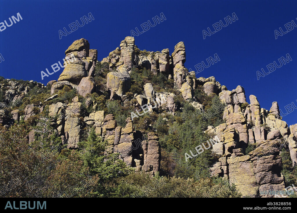 The Chiricahua Apaches called the Chiricahua National Monument area the land of the standing up rocks . This group of rhyolite pinnacles includes the China Boy Formation , named by early settlers.