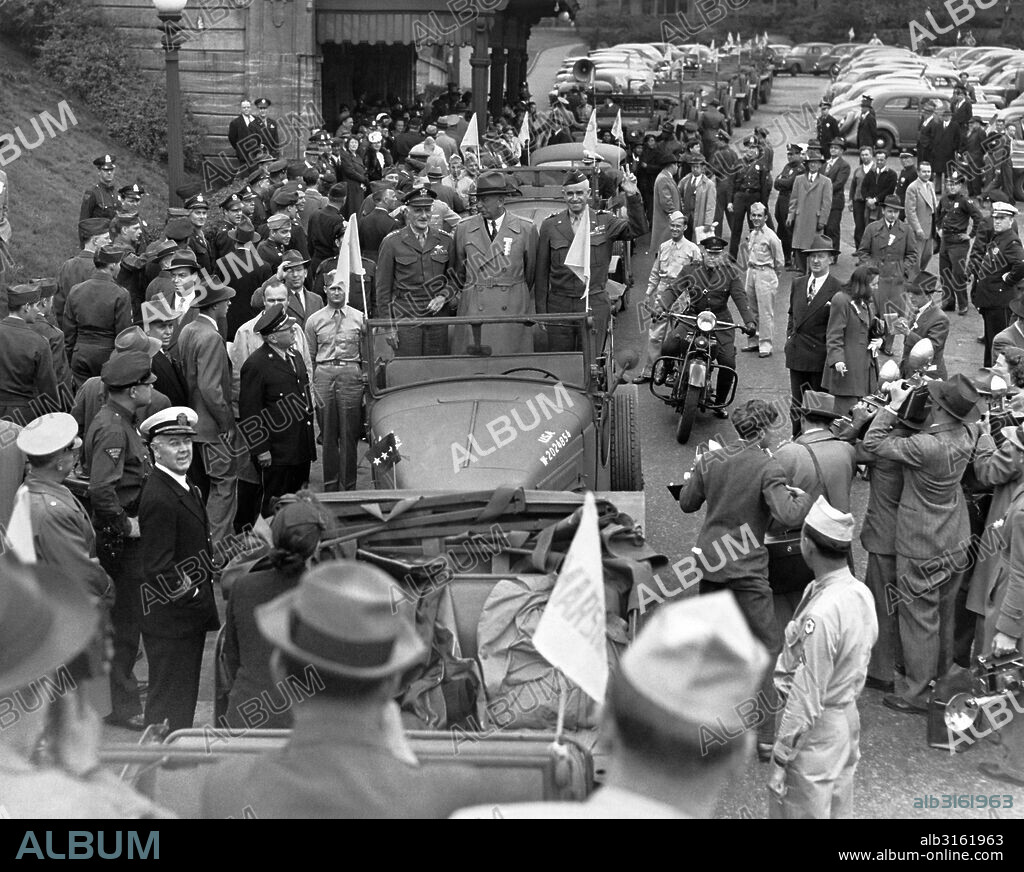 Philadelphia, Pennsylvania: June 6, 1945. L-R, standing in Army car: General Carl Spaatz, Governor Edward Martin, and General Omar Bradley, as they arrive at the North Philadelphia Station.