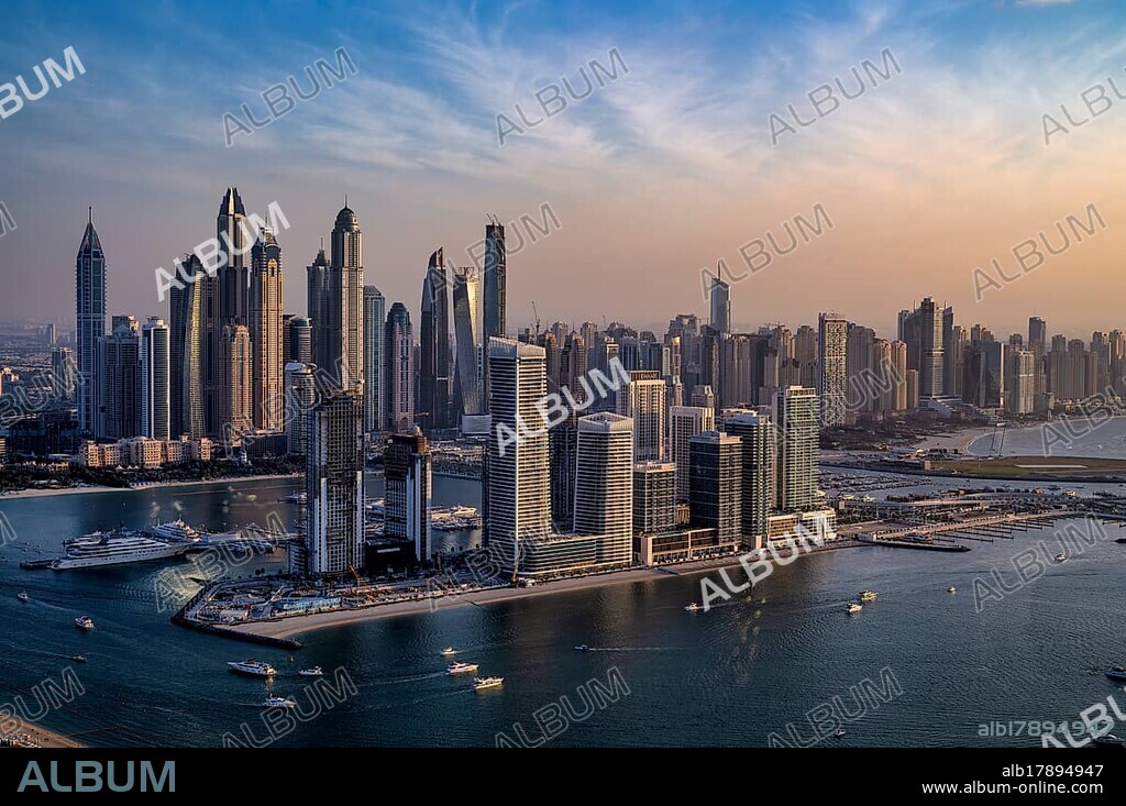 View from The View At the Palm viewing platform onto skyline with Princess Tower, Elite Residence, luxury yacht OPERA owned by Sheikh Mansour bin Zayed Al Nahyan from the ruling family of the Emirate of Dubai, anchored in front of EMAAR Beachfront, Logo, evening mood, Dubai Marina, Dubai, United Arab Emirates, VAR