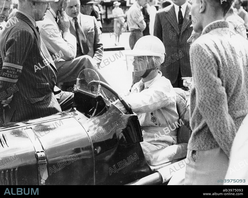 Raymond Mays at the British Empire Trophy Race, Donington Park, Derbyshire, 1939. He was a racing driver of the pre-war period, and played an important role in the creation of the ERA (English Racing Automobiles Ltd) and BRM (British Racing Motors) cars. He was also the first President of the DPRAC (Donington Park Racing Association Club). He started racing in 1921 with a Hillman, specialising in hillclimbs and sprint events. He also raced Bugattis, ACs and Vauxhalls. With Victor Riley he built the 'White Riley' and with the sponsorship from Humphrey Cook the project developed into the ERA. Mays was co-founder and head driver of the team and the cars were built on his home yard at Bourne. In 1937 ERA and Mays dominated the Voiturette season. In 1939 Mays raced his ERA as an independent. After the war Mays continued to compete but gradually became engaged in promoting BRM. He retired from racing after the 1949 International Trophy.