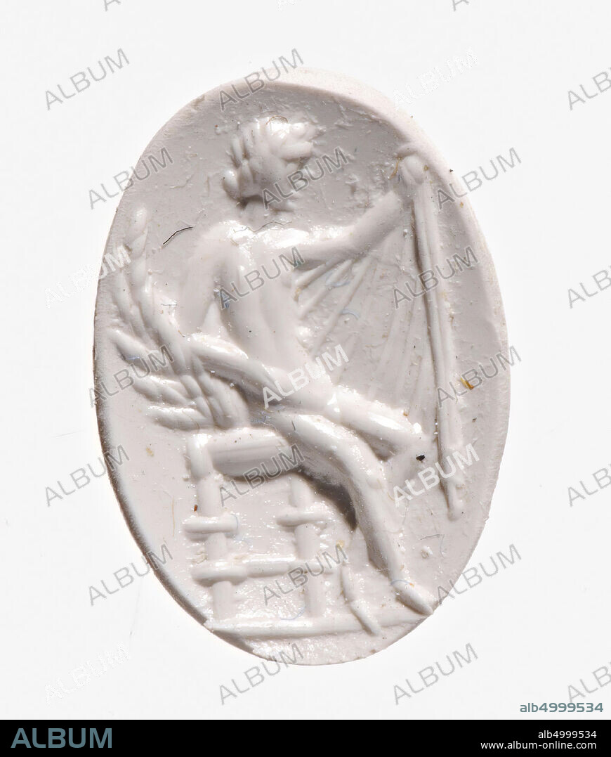 Vz: a naked woman sits on a chair in three-quarter front view, her left arm rests on a large wing while she holds a hemation and a garment in her outstretched other hand., Gem, intaglio, ringstone, plasma, Color: green, Shape: oval, Machining: front and back convex, Method: streaky body modeling with a thick fairly rounded drill, detailing with thick and thin shorts and rounded wheel grooves, 14 x 10 mm, D. 3,5 mm, 1st - 2nd century AD. 1-200 AD.
