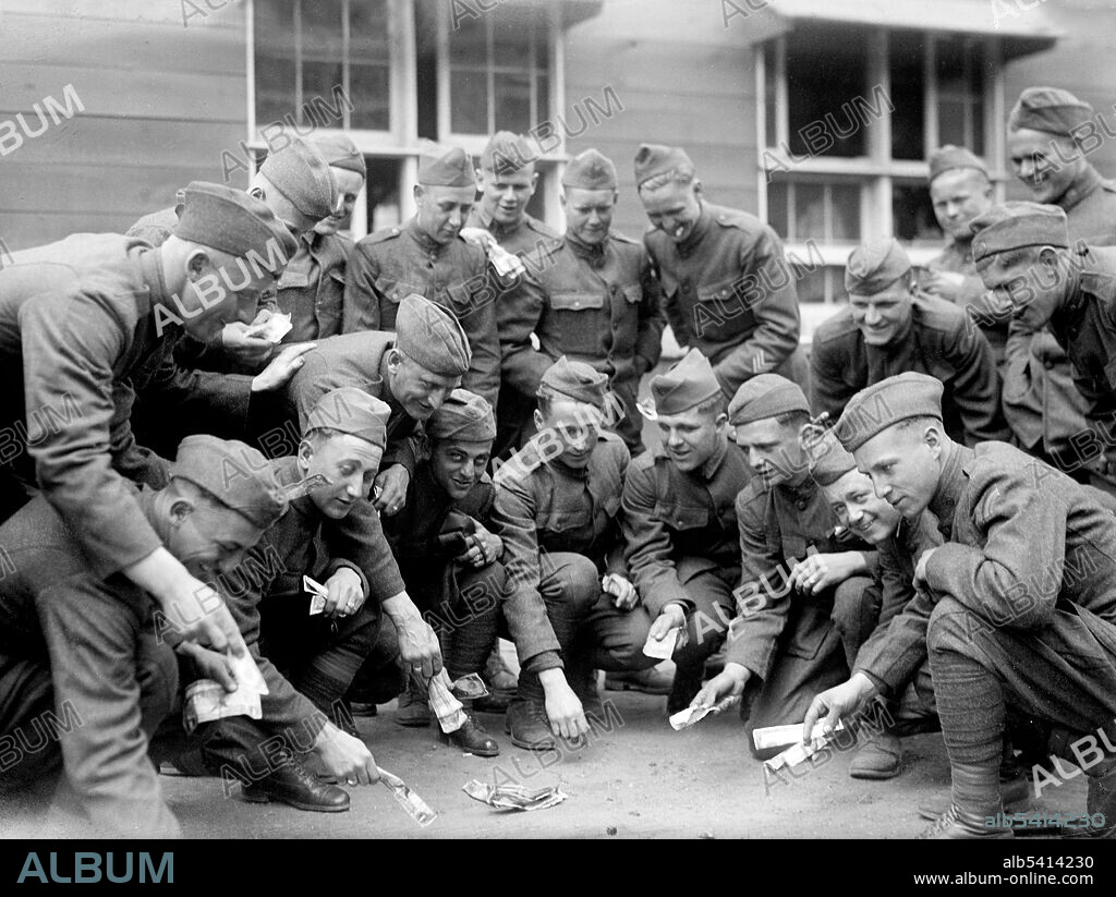 Group of soldiers gambling during a dice game of craps. Shoulder patches identify them as members of the 42nd Infantry Division. Craps is a dice game in which the players make wagers on the outcome of the roll, or a series of rolls, of a pair of dice. Players may wager money against each other (playing street craps) or a bank (playing casino craps AKA table craps. Because it requires little equipment, street craps can be played in informal settings. Bain News Service, circa 1915-20 (cropped and cleaned).