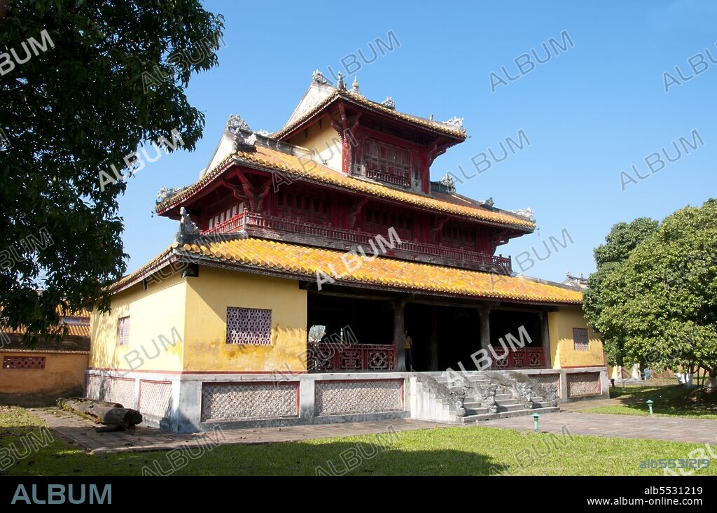 Hien Lam is a monument built to commemorate the Nguyen Dynasty within the Citadel of Hue. It was built in 1821-2 during the reign of Emperor Minh Mang (1791-1841). The shrine is 17m high, making it the tallest structure in the Citadel. Emperor Gia Long ordered the construction of Hue Citadel in 1805. The vast complex is built according to the notions of fengshui or Chinese geomancy, but following the military principles of the noted 18th century French military architect Sebastien de Vauban. The result is an unusual and elegant hybrid, a Chinese-style Imperial City carefully aligned with surrounding hills, islands and waterways, but defended by massive brick walls between 6-12 metres high and 2.5 metres thick, punctuated by towers, ramparts, a massive earth glacis, and 24 Vauban-inspired bastions. The entire complex was further protected by wide moats, crossed by gracefully arched stone bridges leading to ten gates, the chief of which is Cua Ngo Mon, the south-east facing ‘Meridian Gate’. To compound the exotic hybrid effect, guard posts designed as Chinese-style miradors, complete with sweeping eaves crowned by imperial dragons, surmounted each gate. Finally, directly in front of the Ngo Mon Gate, a massive brick fort 18 metres high was constructed both as an additional barrier against malign spirits, and as a defensive redoubt. The area within the Citadel - in all, 520 hectares (1300 acres) - comprises three concentric enclosures, the Civic, Imperial and Forbidden Purple Cities. Access is by way of ten fortified gates, each of which is reached by a low, arched stone bridge across the moat. In imperial times a cannon would sound at 5am and 9pm to mark the opening and closing of the gates. Hue was the imperial capital of the Nguyen Dynasty between 1802 and 1945. The tombs of several emperors lie in and around the city and along the Perfume River. Hue is a UNESCO World Heritage Site.
