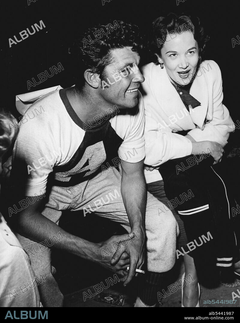 Soon after the birth of their daughter, Dale and Jackie Robertson had -a quarrel and separated. But hardly had this been reported, when they'd kissed and made up Dale played in the annual charity softball match run by stars. October 28, 1952.
