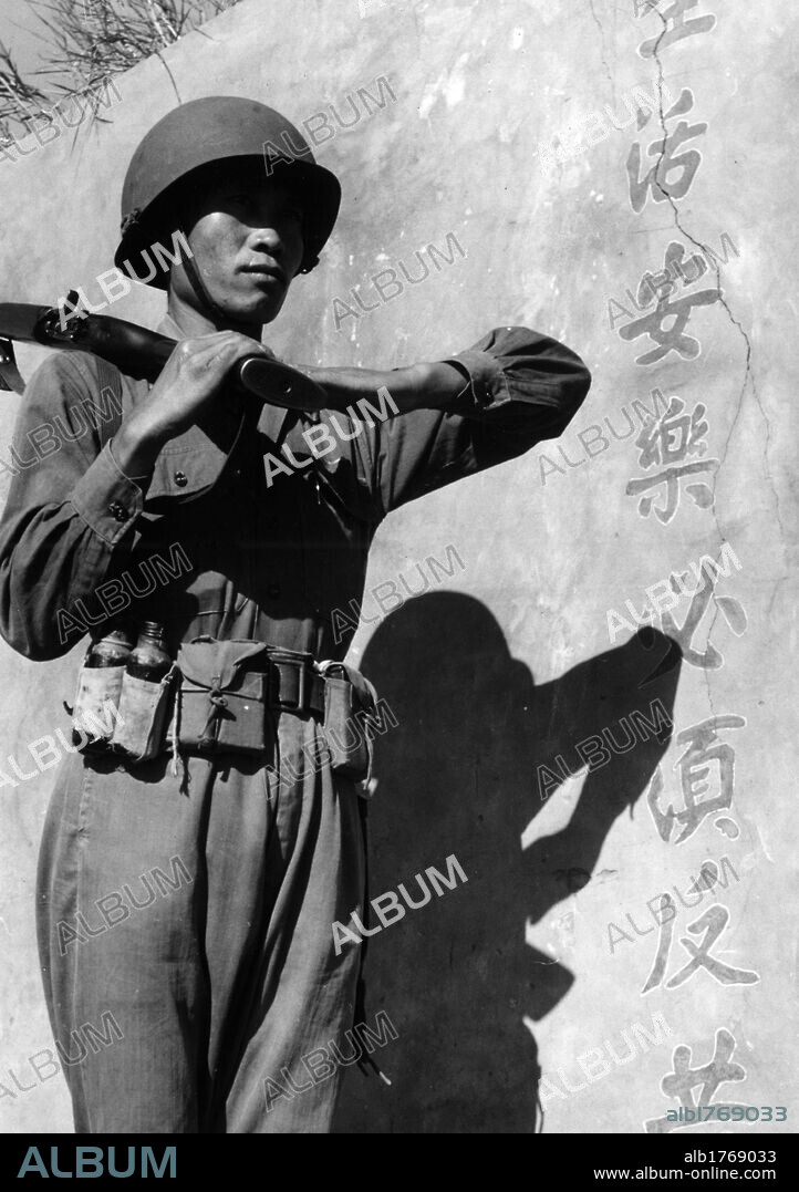 A soldier of Chiang Kai-Shek. A Nationalist soldier in Chiang Kai-shek's army presenting arms. Kinmen, November 1954.