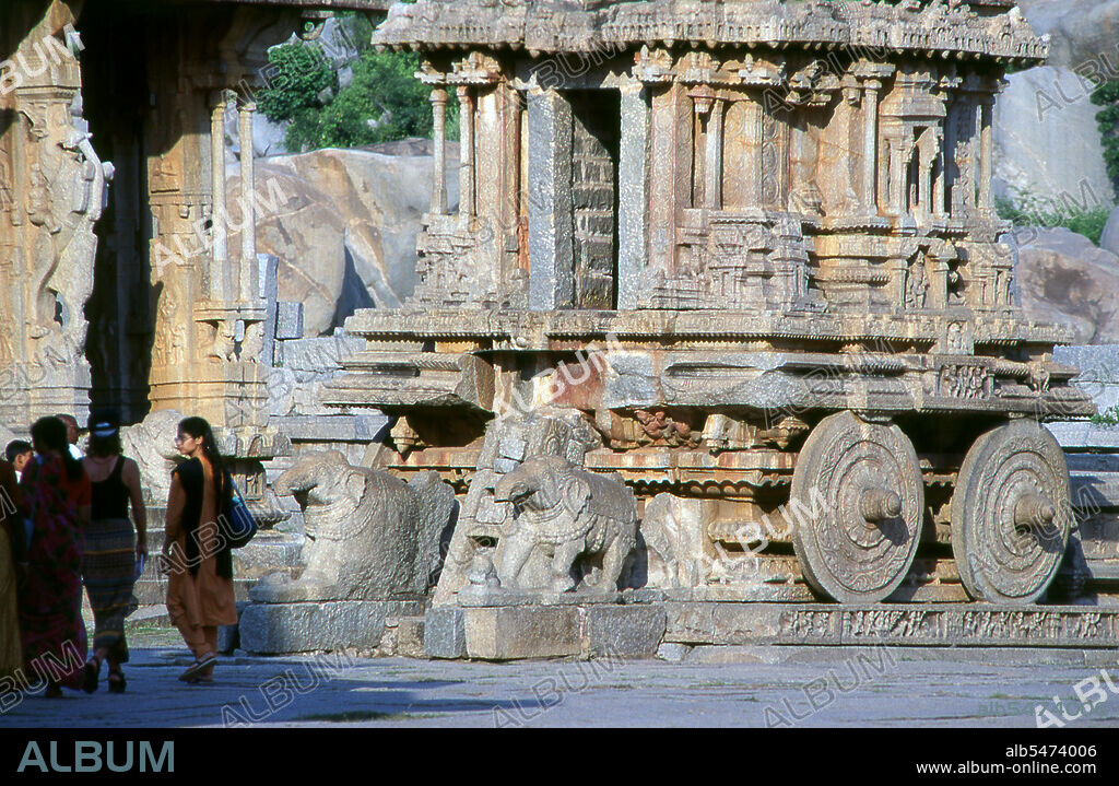The Vittala Temple, built in the early 16th century, is devoted to the Hindu god Vithoba (also known as Vitthala and Panduranga), an incarnation of Vishnu or his avatar Krishna. Hampi is a village in northern Karnataka state. It is located within the ruins of Vijayanagara, the former capital of the Vijayanagara Empire. Predating the city of Vijayanagara, it continues to be an important religious centre, housing the Virupaksha Temple, as well as several other monuments belonging to the old city.