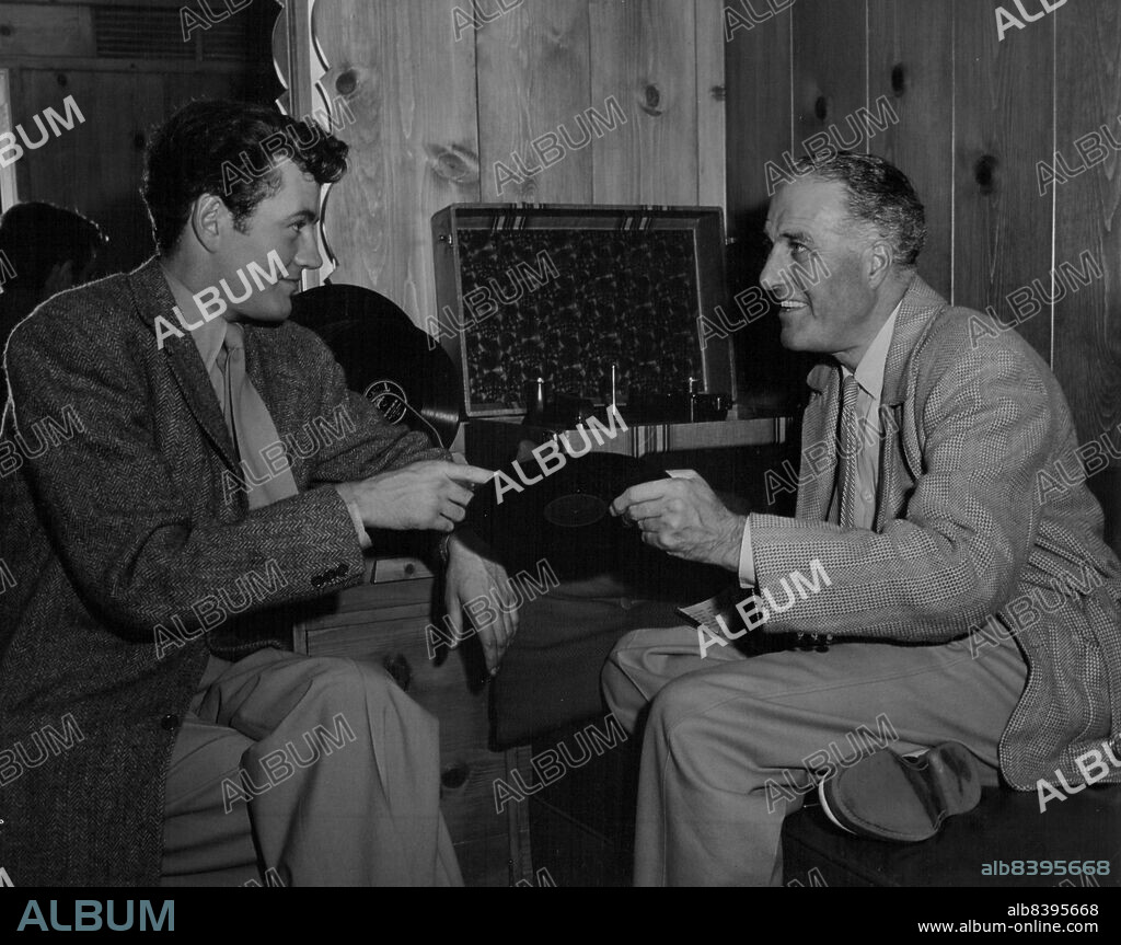 Stars Across The Sea ..... Robert Walker.....who stars in "The Beginning or the End," plays an album of recordings in his dressing room on the set for his guest, Godfrey Tearle.Godfrey Tearle American-born actor who became a star of great Britain's stage and screen bears such a remarkable likeness to the late President Roosevelt that he was signed to portray the role in Metro- Goldwyn-Mayer's "The Beginning or the End," dramatic story of the atom bomb. It was natural that Hollywood stars would want to see him, so here he is greeting the great of American filmdom while he was filming his scenes in "The Beginning or the End," which stars Robert walker and Brian Donlevy, with Tom Drake, Beverly Tyler, Audrey Totter, Hume Cronyn, Hurd Hatfield and many others in the outstanding cast. The film was directed by Norman Taurog and produced by Samuel Marx. July 28, 1948.