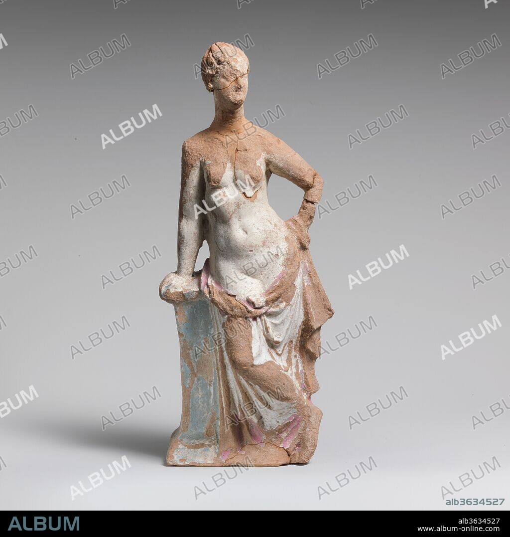 Terracotta statuette of a woman leaning on a pillar. Culture: Greek, South Italian, Tarentine. Dimensions: H. 11 7/16 in. (29.1 cm). Date: 2nd century B.C..
Standing, legs crossed, upper part of figure undraped, leaning right hand on pedestal.