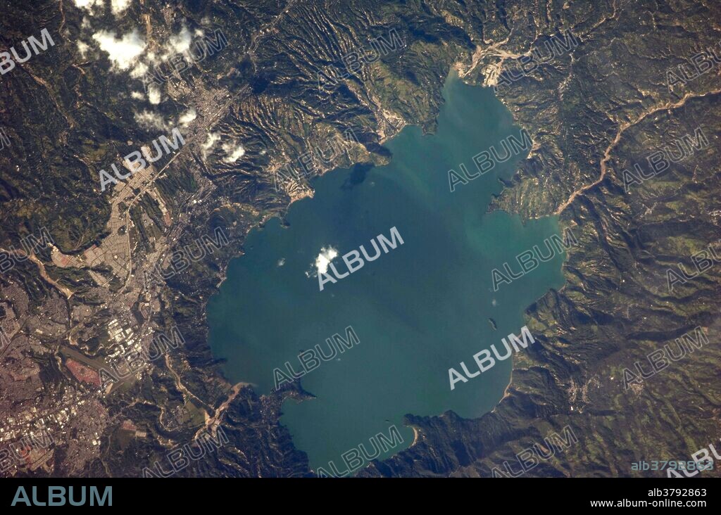 View from space of El Salvador's Ilopango Lake, which is also a caldera. Calderas are the geologic record of powerful volcanic eruptions that empty out a volcano's magma chamber; following the eruption, the overlying volcanic structure collapses into the newly formed void, leaving a large crater-like feature (the caldera).