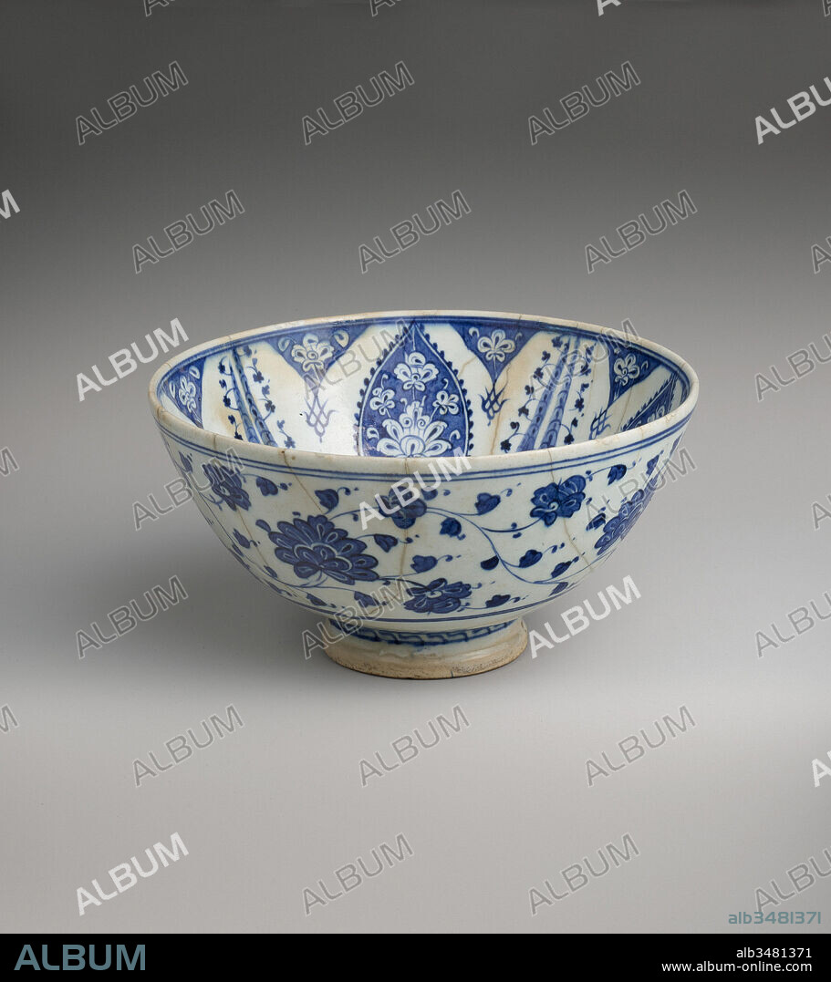 Bowl with Variation of 'Baba Nakkas' Design, ca. 1500–1525, Attributed to Turkey, Iznik, Stonepaste; painted in light and dark blue under transparent glaze, H. 5 3/16 in. (13.1 cm), Ceramics, Some of the earliest Iznik stonepaste ceramics are distinguished by delicate underglaze painted blue decoration on a white ground. The meandering vine of two toned flowers and the white on blue decoration of this small bowl link it to an early group of ceramics referred to as Baba Nakkas (literally, 'Papa Designer') ware named for an artist employed by the Ottoman sultan Mehmed II.