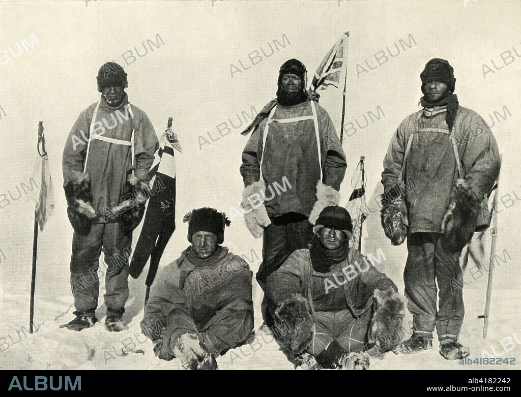 'At The South Pole, (Bowers pulls the string)', January 1912, (1913). Left to right: Captain Lawrence Oates, Captain Robert Falcon Scott, Petty Officer Edgar Evans, seated left to right: Lieutenant Henry Bowers and Dr Edward Wilson in front of flags including the Norwegian flag planted by Roald Amundsen a month earlier. Oates (1880-1912), Evans (1876-1912), Bowers (1883-1912), (1872-1912) and expedition leader Captain Robert F Scott (1868-1912) all died on the way back from the South Pole. The final expedition of British Antarctic explorer Captain Robert Falcon Scott (1868-1912) left London on 1 June 1910 bound for the South Pole. The Terra Nova Expedition, officially the British Antarctic Expedition (1910-1913), included a geologist, a zoologist, a surgeon, a photographer, an engineer, a ski expert, a meteorologist and a physicist among others. Scott wished to continue the scientific work that he had begun when leading the Discovery Expedition to the Antarctic in 1901-04. He also wanted to be the first to reach the geographic South Pole. Scott, accompanied by Dr Edward Wilson, Captain Lawrence Oates, Lieutenant Henry Bowers and Petty Officer Edgar Evans, reached the Pole on 17 January 1912, only to find that the Norwegian expedition under Amundsen had beaten them to their objective by a month. Delayed by blizzards, and running out of supplies, Scott and the remainder of his team died at the end of March. Their bodies and diaries were found eight months later. From Scott's Last Expedition, Volume I. [Smith, Elder & Co., London, 1913].
