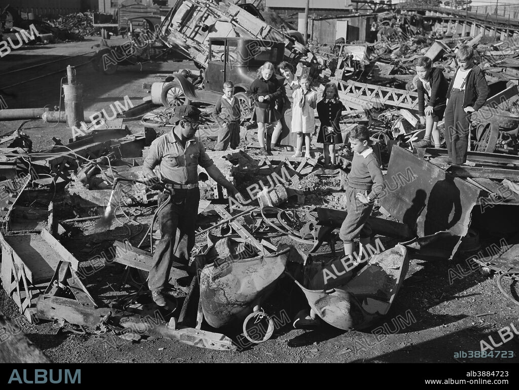 October 1942 - Proud young fighters in Uncle Sam's junior army visit a scrap yard in Roanoke, Virginia to see for themselves what happens to the scrap they collect for our war industries. One of the workers explains to the children how the acetylene torch he holds cuts heavy metal into the shapes required for melting by the steel mills.